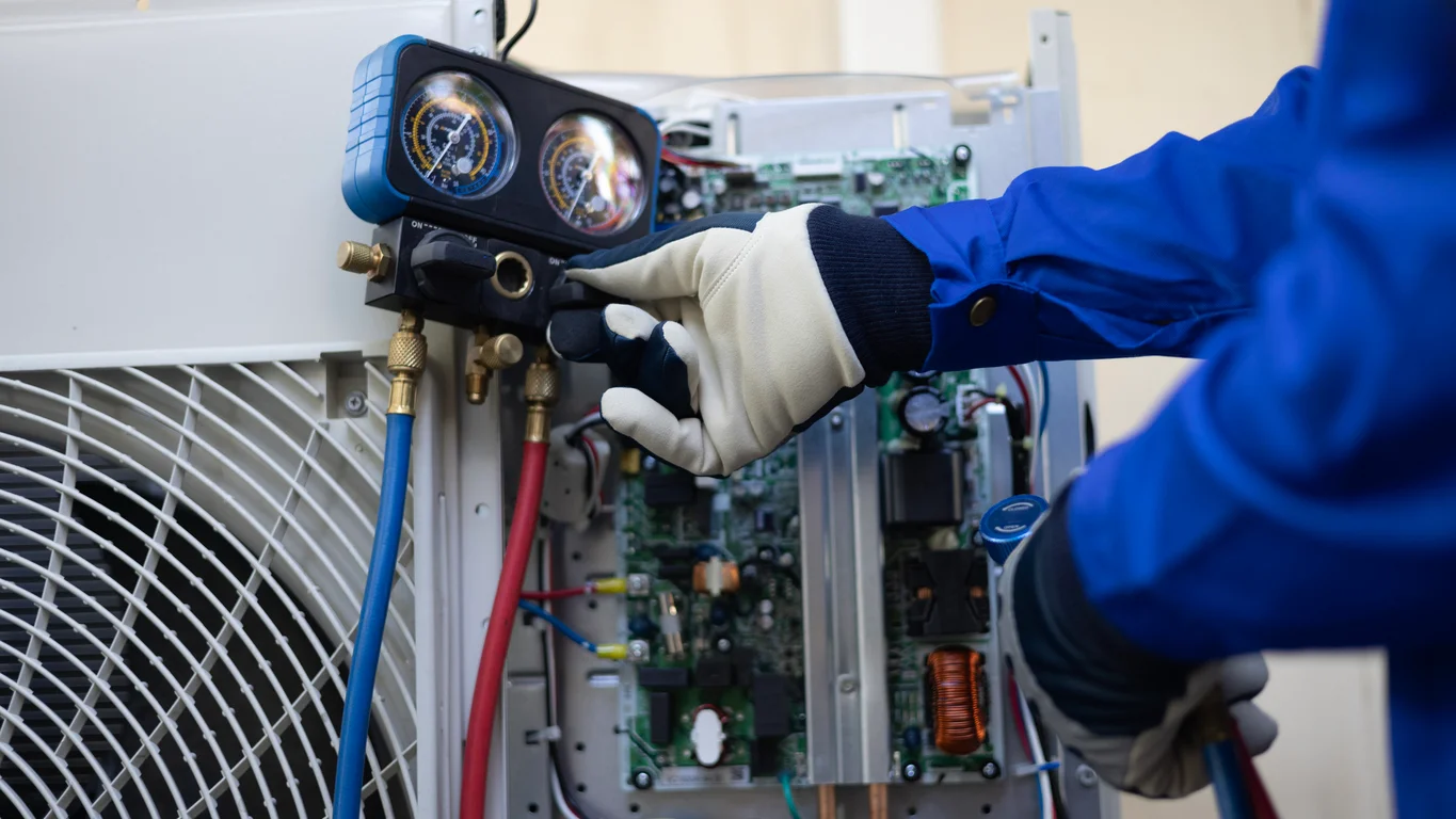 Technician repairing air conditioning equipment